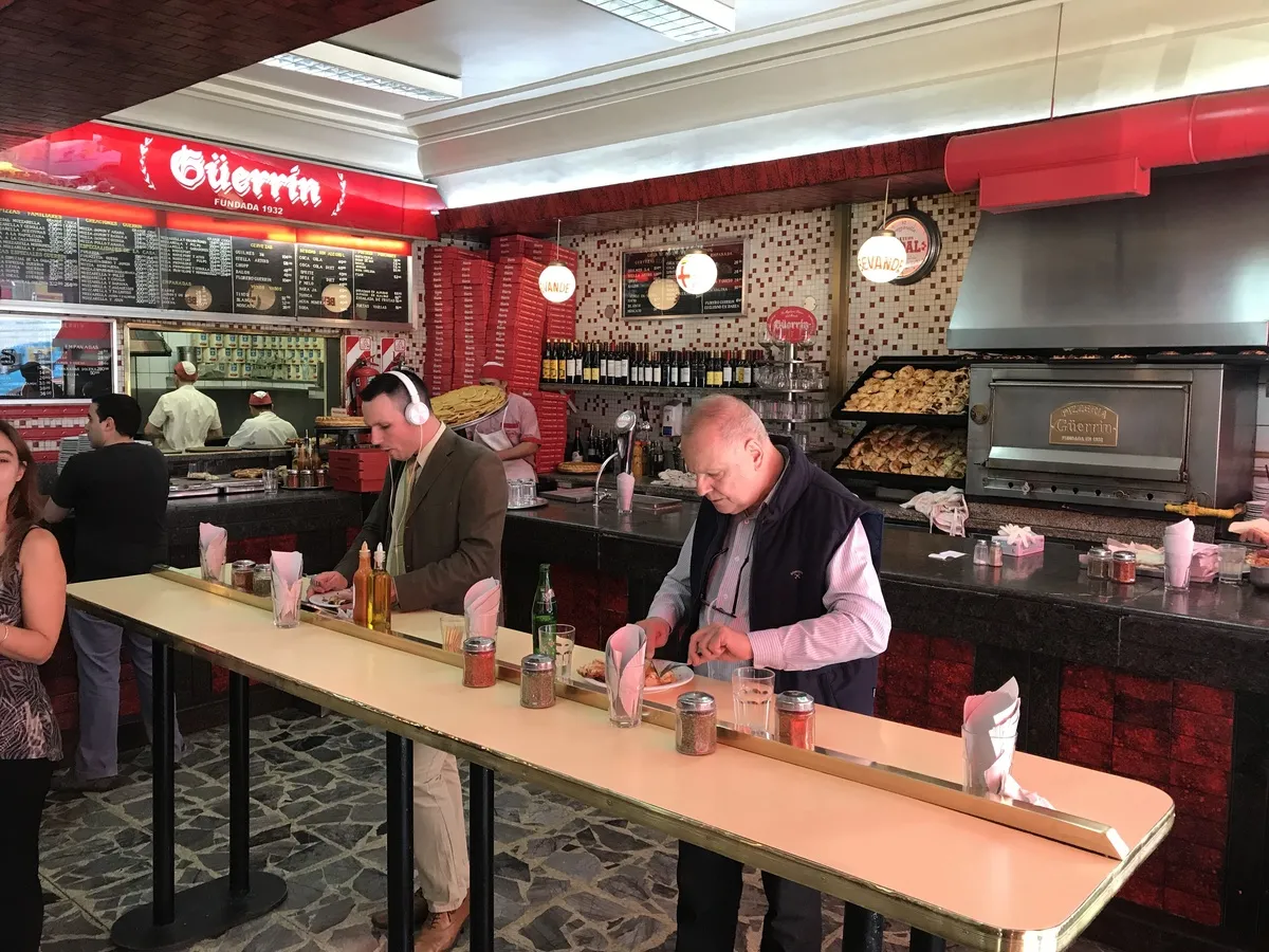 People eating pizza in famous pizzeria guerrin