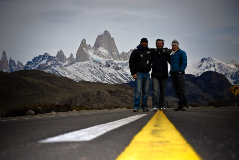 tree guys on the road with cerro fitz roy on the back