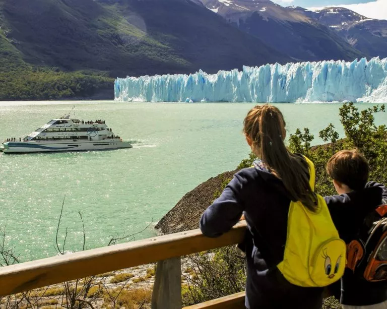 Two kids admiring the Perito Moreno Glacier from the catwalks inside the National Park.