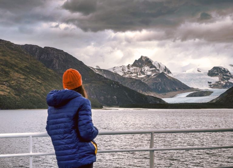 A passenger looking at Patagonia landscape from Australis Cruise