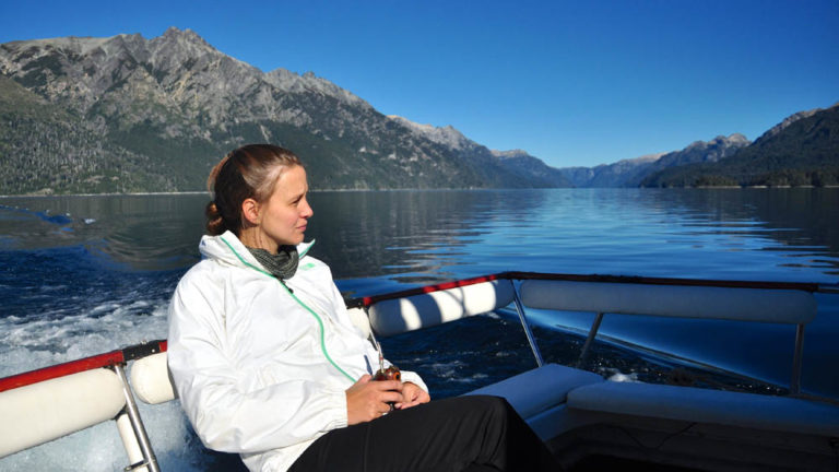 Bariloche-Trip-Tristeza-Sound-3 A woman enjoying landscapes from the deck of Tristeza Sound navigation.