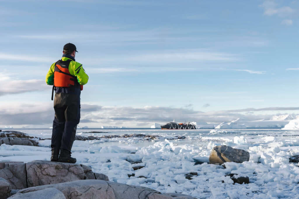 A man watching the beautiful landscape of Antarctica.