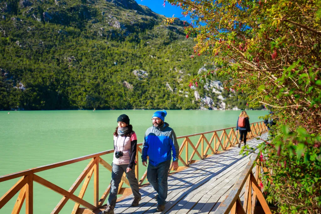 Couple walking in the wood walkways in caleta tortel