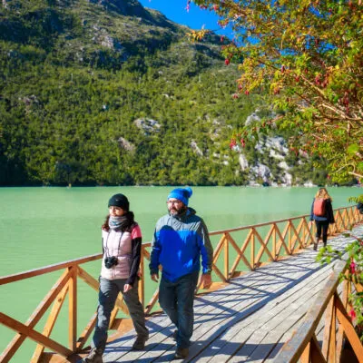 Couple walking in the wood walkways in caleta tortel