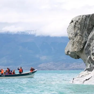 A group of peolple in a boat exploring the marvel caves