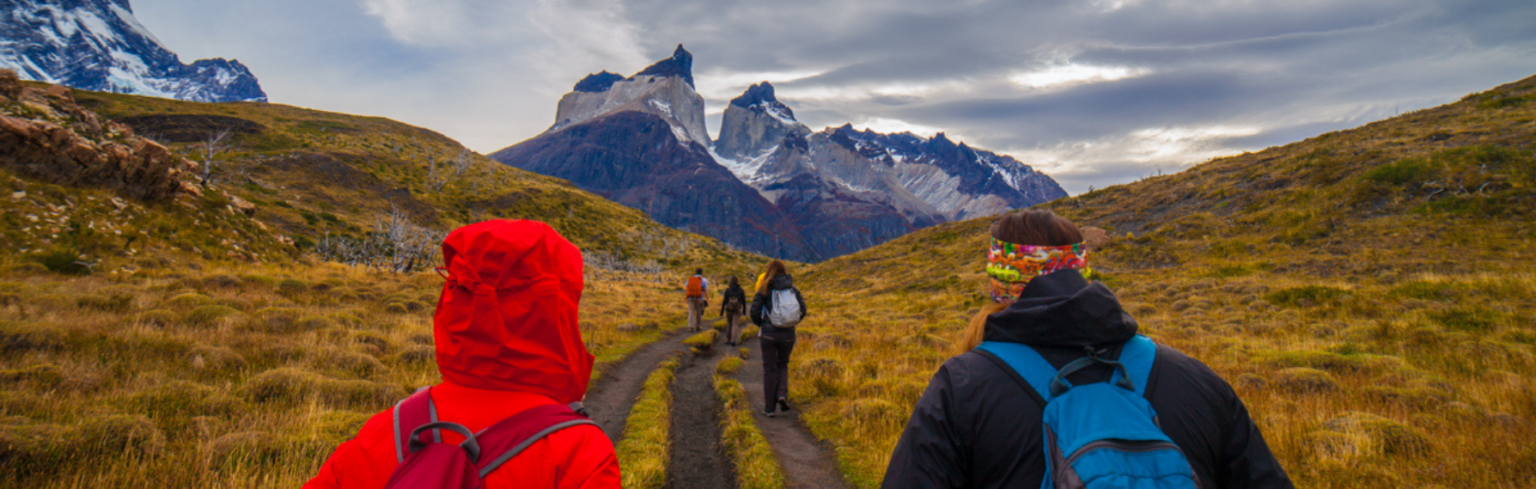 Group of hikers doing a trek to a viewpoint of Los Cuernos del Paine