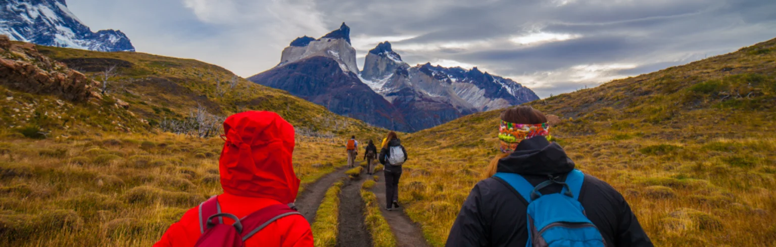 Group of hikers doing a trek to a viewpoint of Los Cuernos del Paine