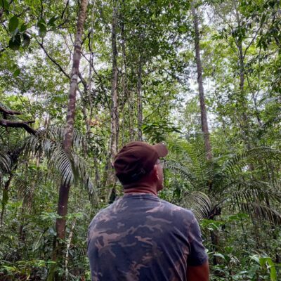 man backwards contemplating nature in te amazon - 