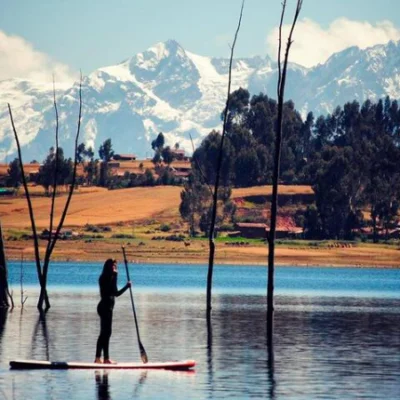 women padeling in a surfboard in peru