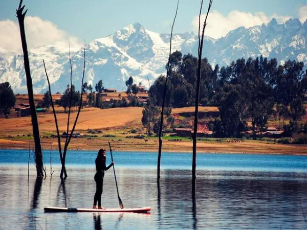 women padeling in a surfboard in peru