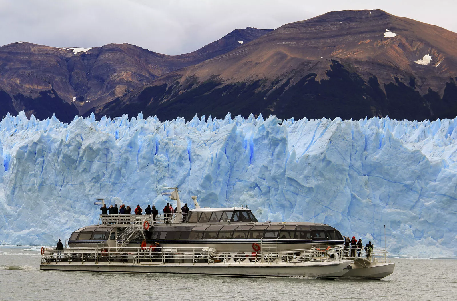 view of érito moreno glacier with boat sailing in the lake