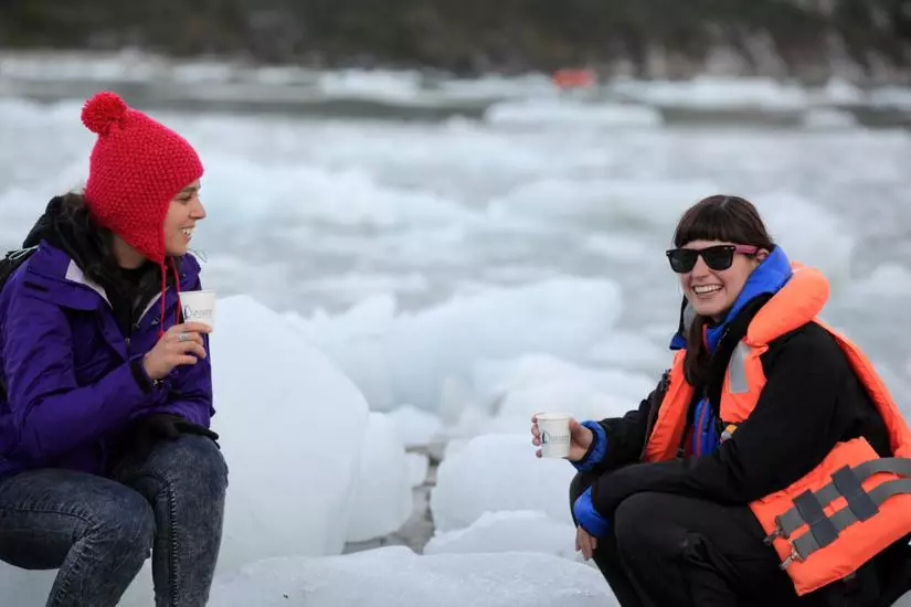 Patagonia Cruises Australis Cruise, women holding pieces of ice.