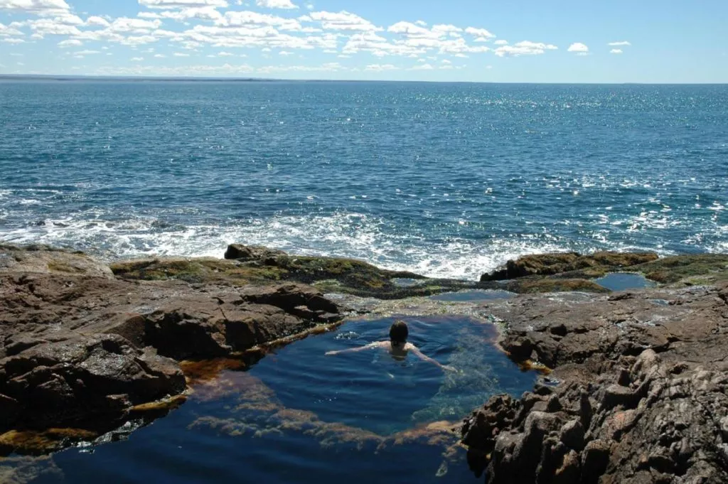 A person bathing in a natural pool in Puerto Madryn, Patagonia.